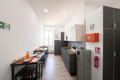 a kitchen with a table and chairs and a refrigerator at Trastevere New Luxury Rooms in Rome