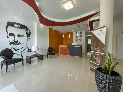 a lobby with a drawing of a man with a beard at Hotel Vista in Praia
