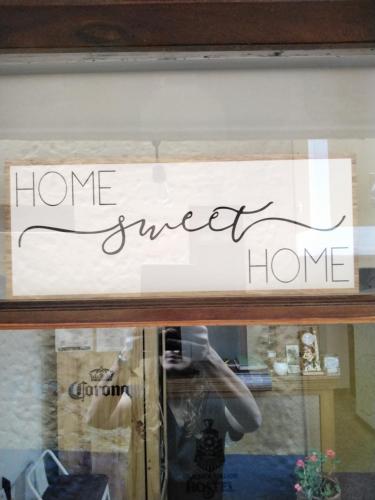 a sign in the window of a home sweet home at Usaquen Station Hostel in Bogotá
