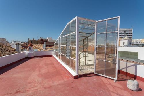 a glassarium on the roof of a building at Blife Alicya private rooms in Faro