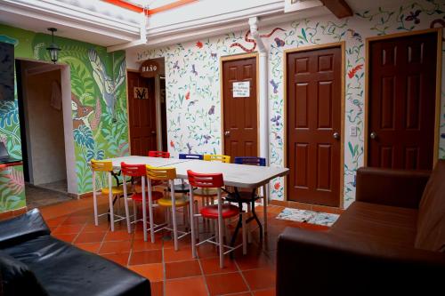 a dining room with a table and chairs at Usaquen Station Hostel in Bogotá