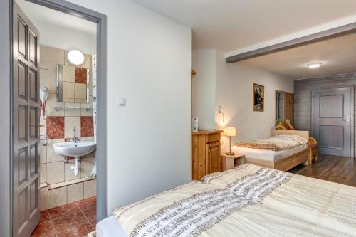a bathroom with two beds and a sink in a room at Ludwighaus in Neukirchen am Großvenediger