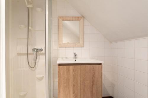 a bathroom with a sink and a shower at Domaine de la Blanche Hermine in Plounérin