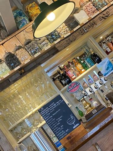 a bar with a lot of bottles of alcohol at Clydfan No 1 Trearddur Road in Trearddur