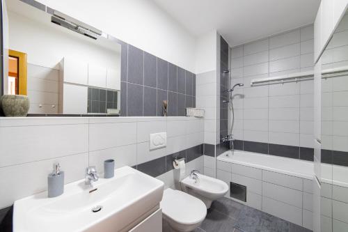 a white bathroom with a sink and a toilet at Skenderpasina Skyline 2-bedroom apartment with balcony in Sarajevo