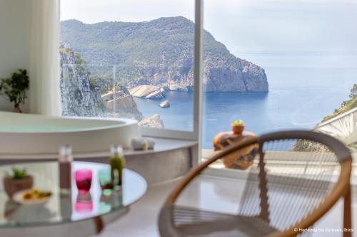 a room with a view of the ocean at Hacienda Na Xamena, Ibiza in Na Xamena