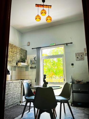 a kitchen with a table and chairs and a window at Savvinio Country Apartment in Alexandroupoli