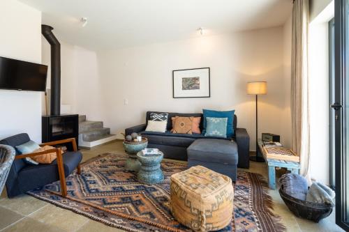 a living room with a couch and a table at Viladraga - Casa da Adraga in Colares
