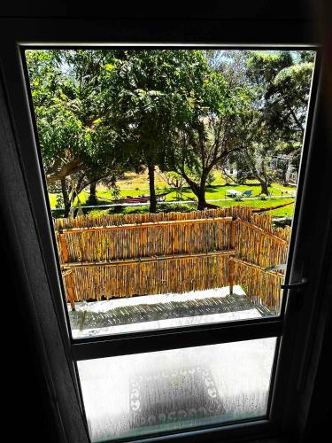 a window view of a park with a fence at Savvinio Country Apartment in Alexandroupoli