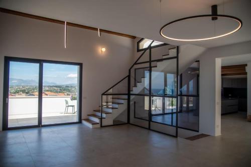a room with a staircase and a large window at Tenuta Rapillo in Castellammare del Golfo