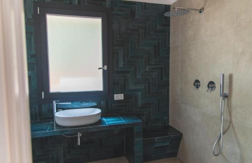 a bathroom with a white sink and a window at Tenuta Rapillo in Castellammare del Golfo