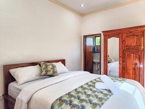 Postel nebo postele na pokoji v ubytování Wisuda Guest House