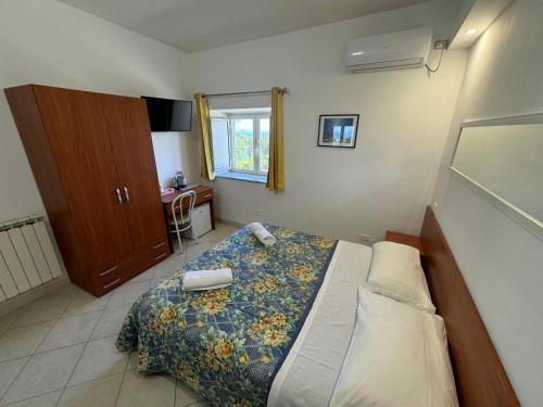 a small bedroom with a bed and a window at Agriturismo Piccolo Paradiso in Piano di Sorrento