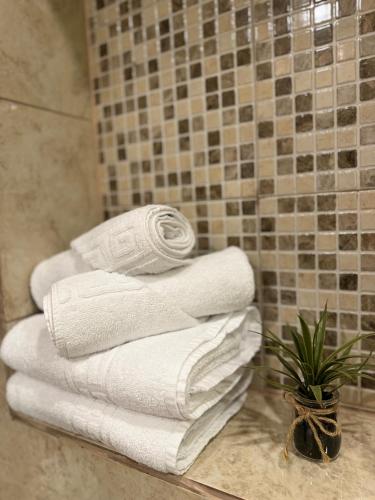 a pile of white towels in a bathroom at Ada's Luxury Apartment - Old City in Braşov