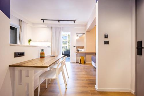 a kitchen and dining room with a table and chairs at The Dorians in Athens