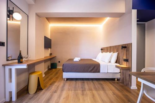 a hotel room with a bed and a desk at The Dorians in Athens