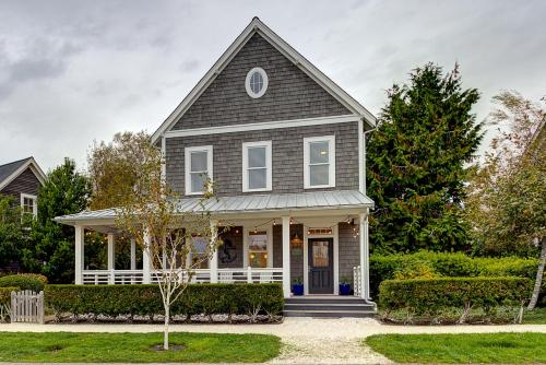 a gray and white house with a porch at Beaches-N-Cream by Seabrook Hospitality in Pacific Beach