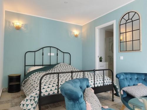 sypialnia z łóżkiem i niebieskimi ścianami w obiekcie Quinta Da Rocha Portimao w mieście Mexilhoeira Grande