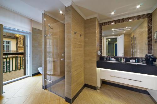 a bathroom with a shower and a sink at EA Hotel Atlantic Palace in Karlovy Vary
