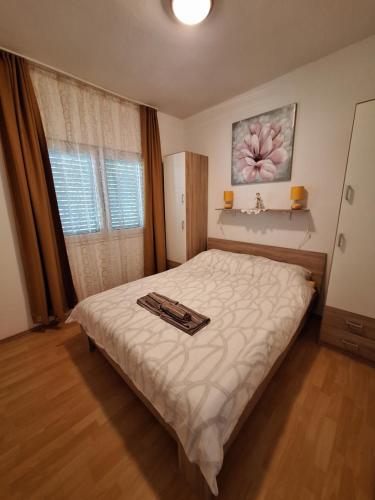 a bedroom with a bed with a tray on it at Kuca za odmor Vila Bella in Karlobag