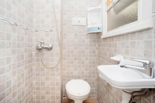 a bathroom with a toilet and a sink and a shower at Administracion Callao in Buenos Aires