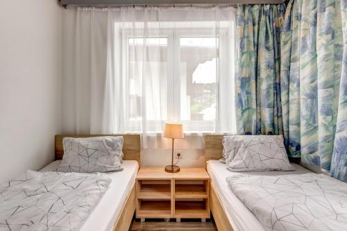 two beds in a room with a window at Ludwighaus in Neukirchen am Großvenediger