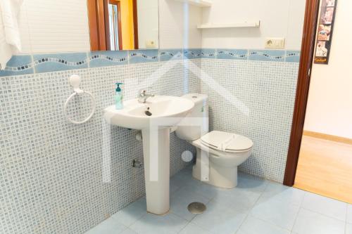 a bathroom with a sink and a toilet at Apto Galiana - En Avilés centro. in Avilés