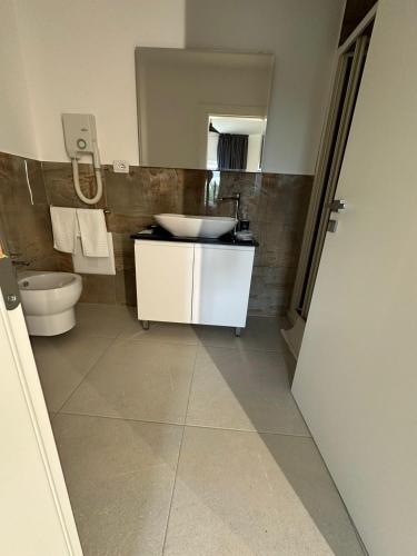 a bathroom with a sink and a toilet at Evergreen Laguna Vain-Lezhe in Lezhë