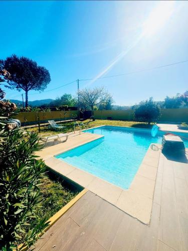a large swimming pool with a rainbow in the sky at Refúgio das Serras do Porto-Luz&Martins Alojamento in Paredes