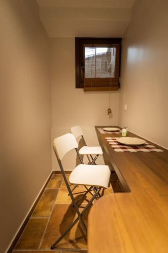 a room with three white chairs sitting at a counter at Paleologou Studio in the Castle in Ioannina