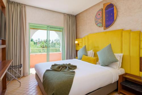 Säng eller sängar i ett rum på Palmeraie Green Resort Marrakech & Spa