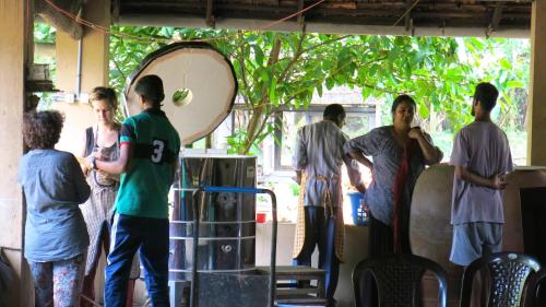 a group of people standing around in a room at Clayfingers Art Cottage in Trichūr
