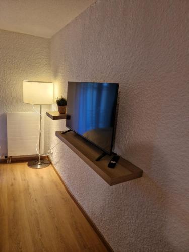 a flat screen tv on a wall in a room at Studio SIEVA in Lausanne