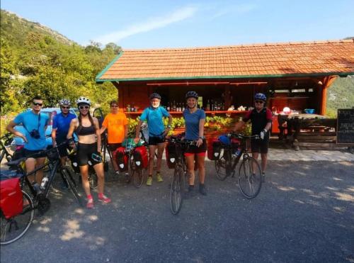 a group of people on bikes in front of a building at Camp Oaza,Lipa in Cetinje