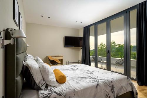 a bedroom with a bed and a large window at Villa She Luxury in Boškari