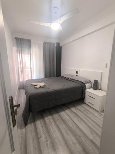 a bedroom with a bed and a dresser and a window at Apartamento San Antón in Huesca