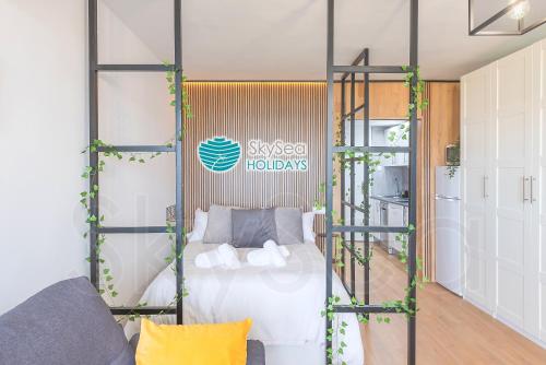 a bedroom with a bed in a glass room at Sky Sea Holidays Calahonda LA ALGAIDA in Sitio de Calahonda