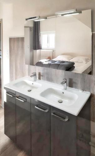 a bathroom with a sink and a bed at Maison de 7 chambres avec jardin clos et wifi a Montsalvy in Montsalvy
