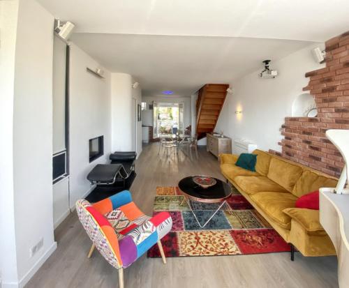 a living room with a couch and a table at Maison de 2 chambres a Marseille a 200 m de la plage avec vue sur la mer jardin clos et wifi in Marseille