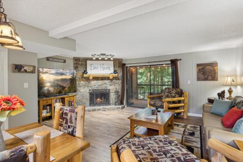 a living room with a couch and a fireplace at Obear Mountain is a Newly Updated Condo in Chalet Village of Gatlinburg! in Gatlinburg