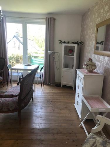 un salon avec une table et une salle à manger dans l'établissement 10 Rue Bardeau,Fougerolle du Plessis,France,53190, à Fougerolles-du-Plessis