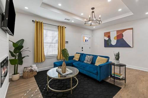 a living room with a blue couch and a table at Westside Charm in Atlanta