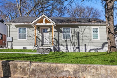 a white house with a tree in front of it at Westside Charm in Atlanta