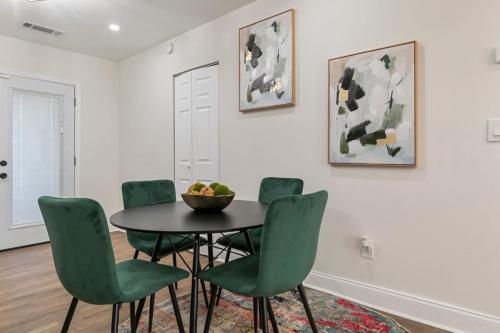 a dining room with a table and green chairs at Westside Charm in Atlanta