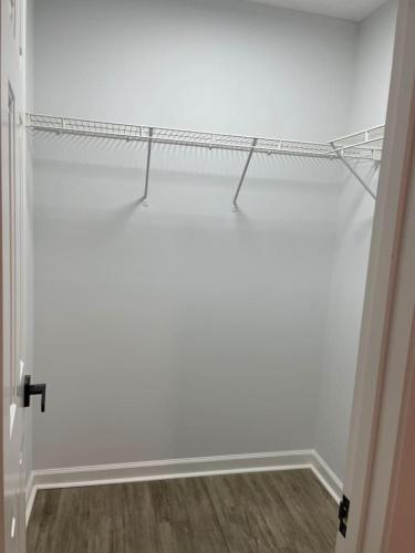 a room with a white wall with a shelf at Spacious 3BR Oasis in Mableton