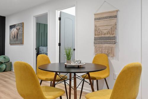 a dining room with a table and yellow chairs at Comfy 2 bedroom w Free Parking in Austell