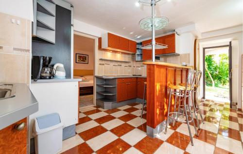 a kitchen with a checkered floor at Lovely Apartment In Rovanjska in Rovanjska