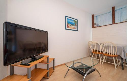 a living room with a large flat screen tv at 1 Bedroom Nice Apartment In Rovanjska in Rovanjska
