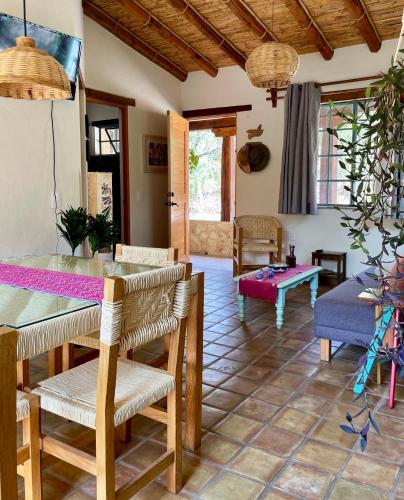 a living room with a table and chairs at El Pocito Quiet Bungalow in Oaxaca City