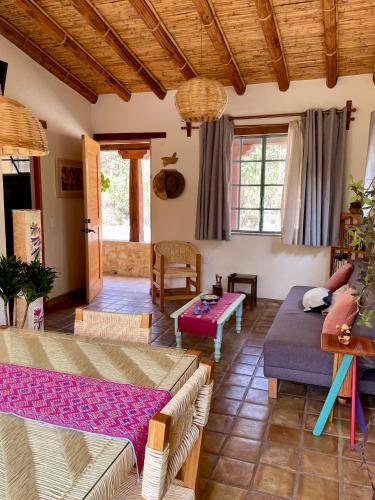 a living room with a couch and a table at El Pocito Quiet Bungalow in Oaxaca City